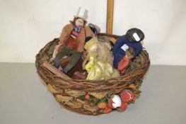 Basket of vintage costume dolls
