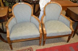 A pair of early 20th Century bow back chairs together with a roll of matching fabric