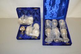 Two blue fabric covered cases of silver plated goblets
