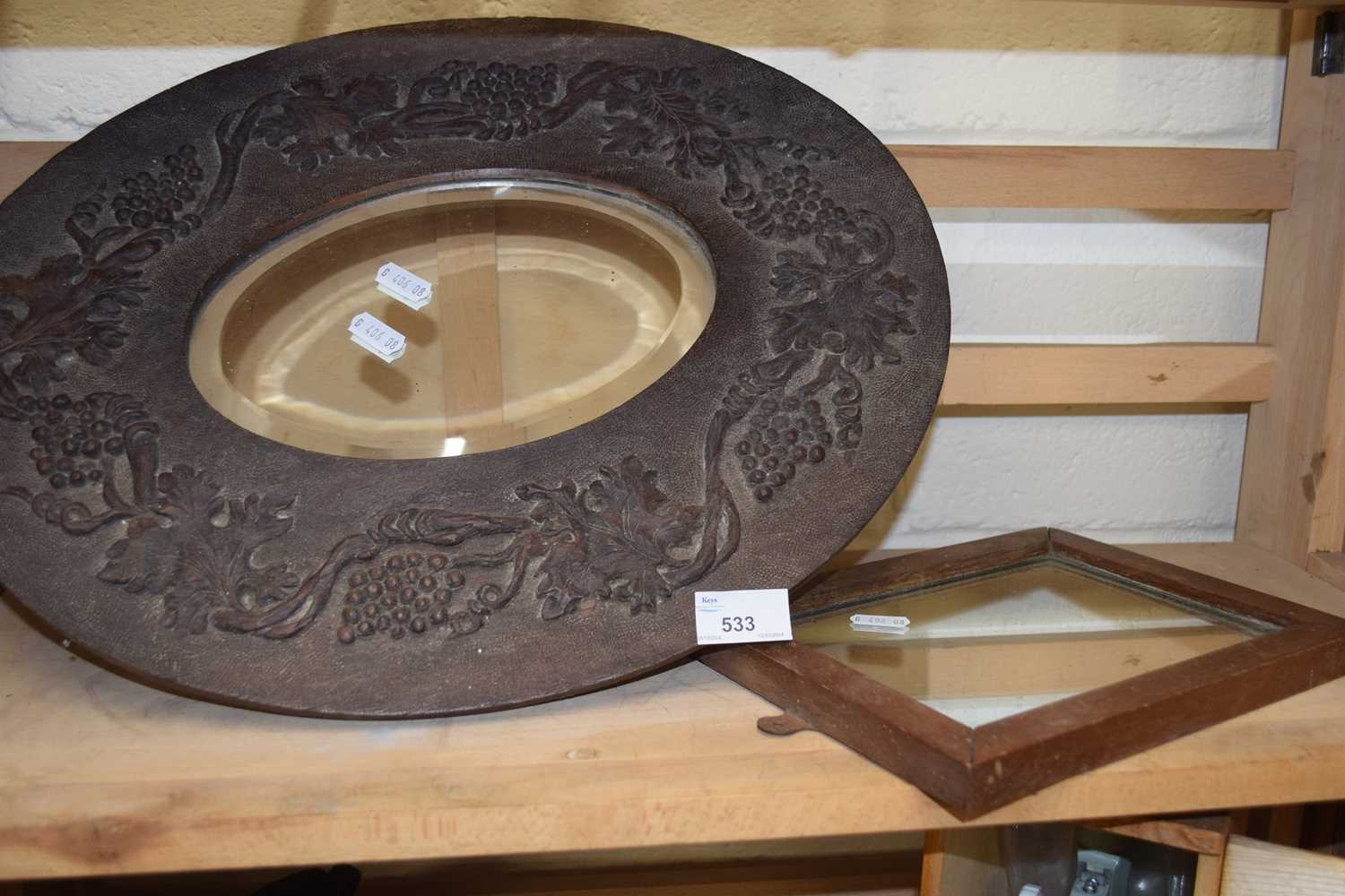 A carved wooden framed oval wall mirror and a small rectangular mirror (2)