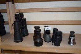 A pair of Grosvenor 12 x 50 binoculars together with another smaller pair and three pairs of opera