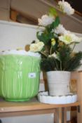 Two large plant pots and an artificial floral arrangement