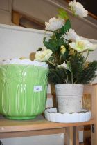 Two large plant pots and an artificial floral arrangement
