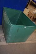 Green plastic and plywood wheeled container from a laundry