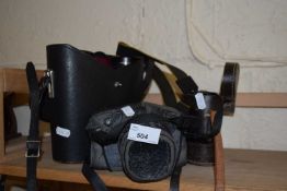 A Pentax SLR camera and case together with a lens, a Pentax pair of binoculars 7x50 and another pair