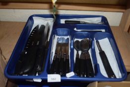 A canteen of black plastic handled flat ware and a quantity of assorted kitchen knives