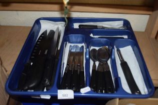 A canteen of black plastic handled flat ware and a quantity of assorted kitchen knives