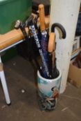 Modern ceramic stick stand with various walking sticks and umbrellas