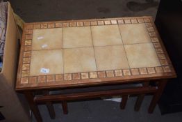 A nest of three tiled top coffee tables