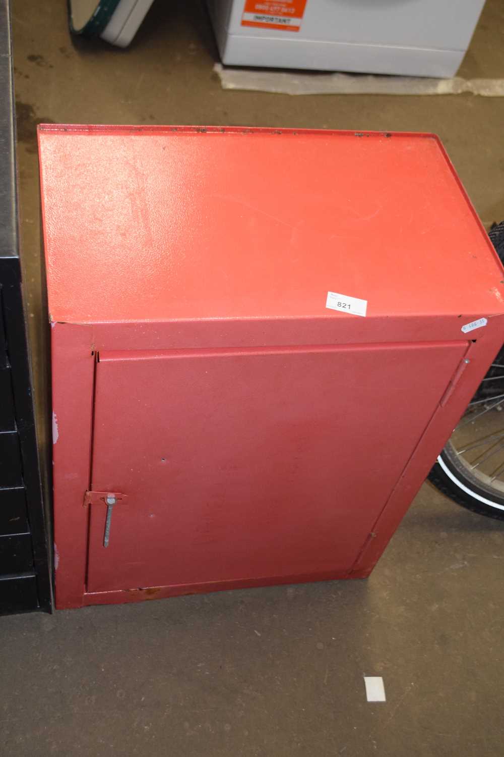 A red metal wall cabinet