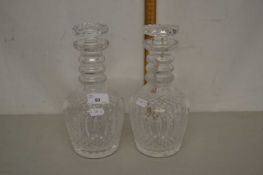 A pair of cut clear glass decanters