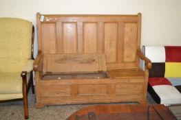 Pine box settle, panelled back and two storage sections to the seat, 148cm wide