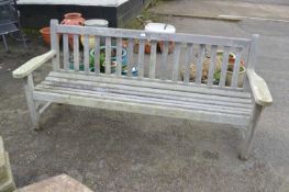 A large hardwood garden bench, 191cm wide