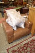 Brown leather armchair and associated cushions