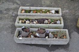 Three rectangular concrete planters