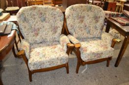 A pair of floral upholstered armchairs, possibly Ercol