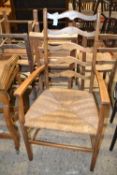 A rush seated ladder back carver chair