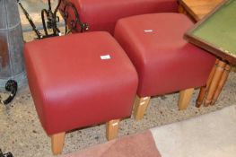 A pair of modern red upholstered stools