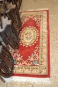 Small red patterned floral rug