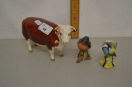 A Beswick model of a cow together with two further Beswick birds