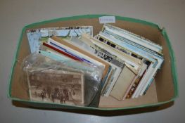 A box of various assorted postcards