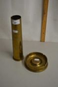 A brass shell case and a further ashtray made from the base of a shell case
