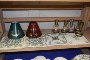 Four decorative tiles, metal candlesticks and shades