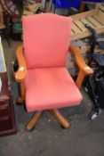 A pine upholstered swivel office chair