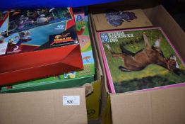 Two boxes of various jigsaw puzzles, games etc