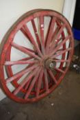 Two red painted carriage wheels, approx 117 diameter