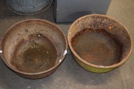 Two circular iron bowls or troughs