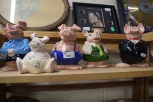 Five Nat West piggy bank pigs