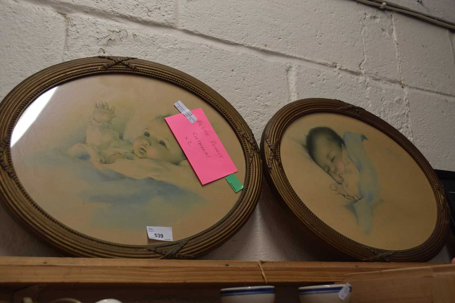 Two prints of babies in oval frames by Bessie Pearce Gutmann