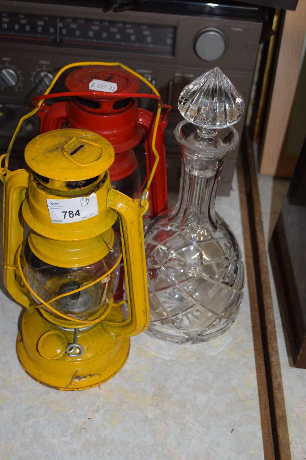 Two paraffin lamps and a glass decanter