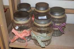 Five glass storage jars with metal lids