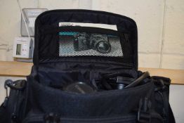 A Yashica FX-D camera, assorted lenses, bag and equipment