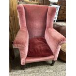 An early 20th Century wing back armchair