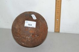 Cast iron ball, possibly a cannon ball or from a ball and chain, unmarked with small slightly