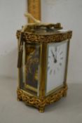 20th Century French carriage clock with serpentine case and pierced metal decoration, 12cm high