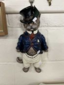 A comical wall plaque of a smartly dressed cat