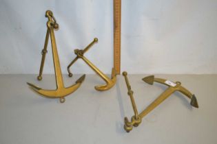 Three small brass anchors