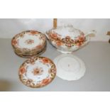 Gilt decorated soup tureen and accompanying plates