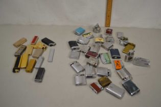 Two boxes containing a collection of various mainly steel cigarette lighters to include Ronson and