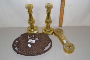 An iron pot stand together with pair of brass candlesticks and a poker stand (4)