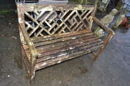 Weathered wooden garden bench with lattice work back