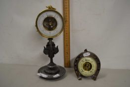 Brass cased aneroid barometer on a spelter base together with a further barometer in horseshoe