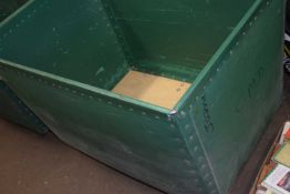 Plywood and green plastic laundry bin on casters