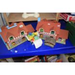 Two Fisher Price fold-out toy houses and contents