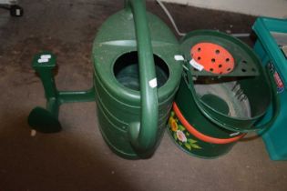 A watering can, floral painted mop bucket and a cast iron shoe last