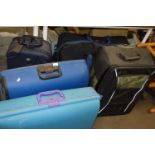 Five assorted suitcases